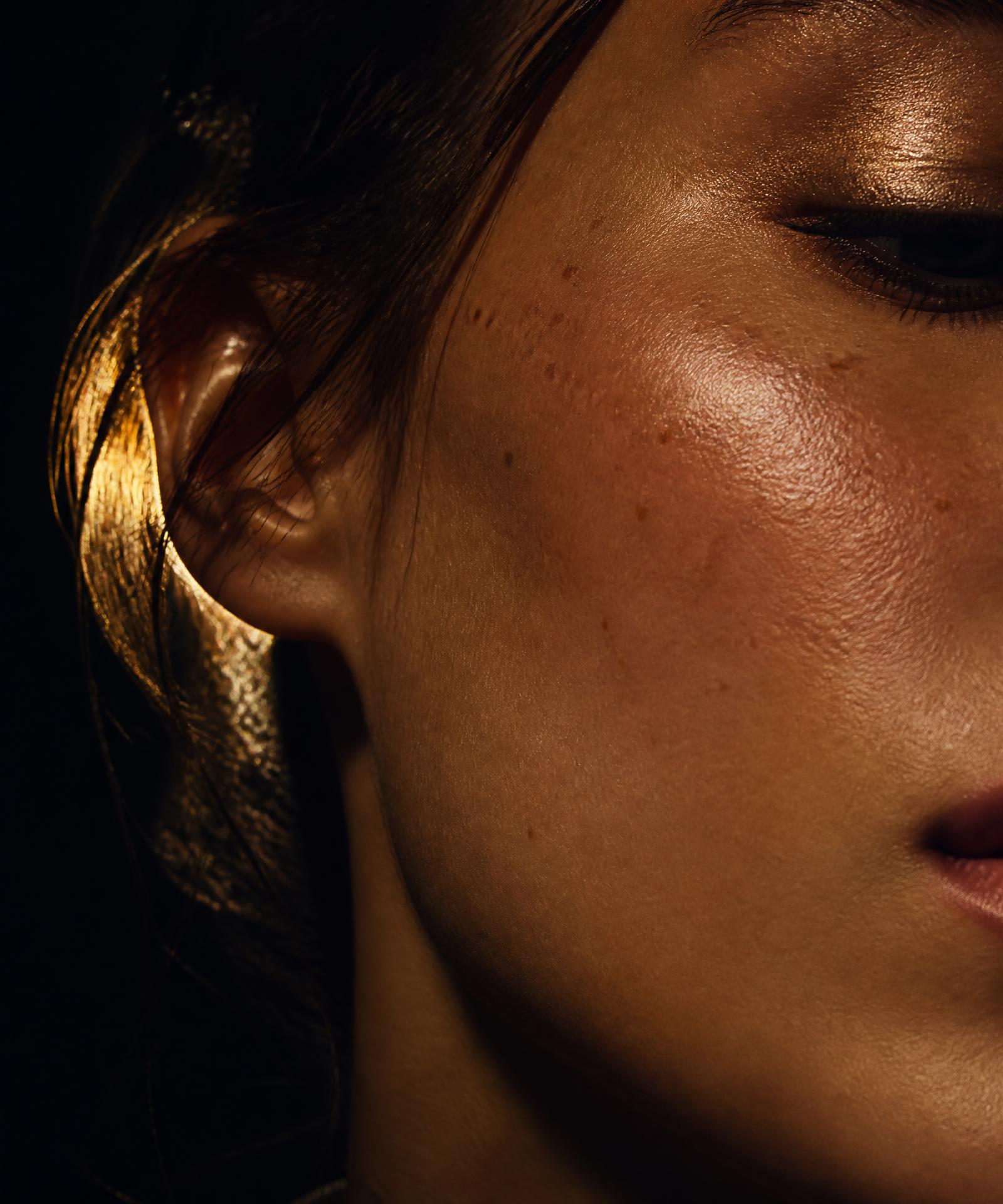 Close macro of luminous skin under warm directional light